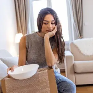 Woman sadly holding item